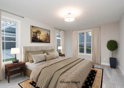 Neutral-toned bedroom with a large upholstered bed, two wooden nightstands, and matching lamps; beige bedding and curtains give a calm, staged look. A framed landscape painting hangs above the headboard; a tall potted plant sits in the corner, and a patterned rug anchors the room. The words 'Virtually Staged' appear on the bedspread.
